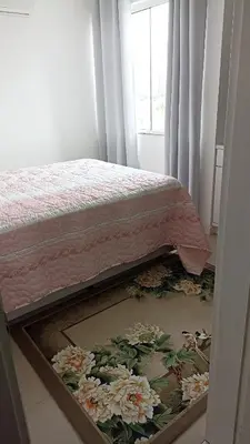 Uma cama ou camas num quarto em Apto temporada Itapema sc