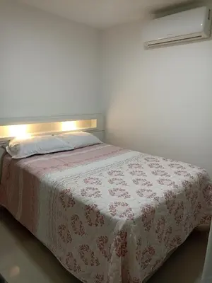Uma cama ou camas num quarto em Apto temporada Itapema sc
