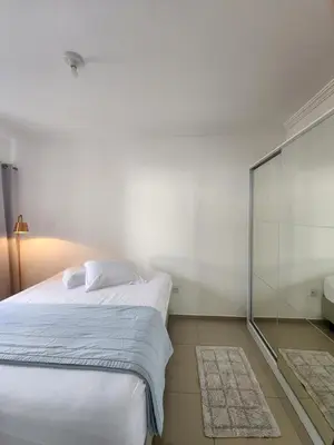 Uma cama ou camas num quarto em Apartamento Balneário Camboriú