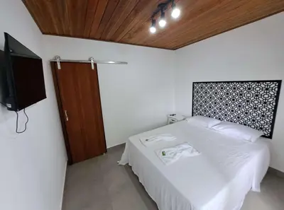 Uma cama ou camas num quarto em Hospedaria da Barra BC