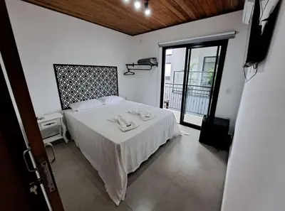 Uma cama ou camas num quarto em Hospedaria da Barra BC