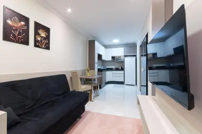 Uma televisão e/ou sistema de entretenimento em Hotel Gigante Beach Itapema